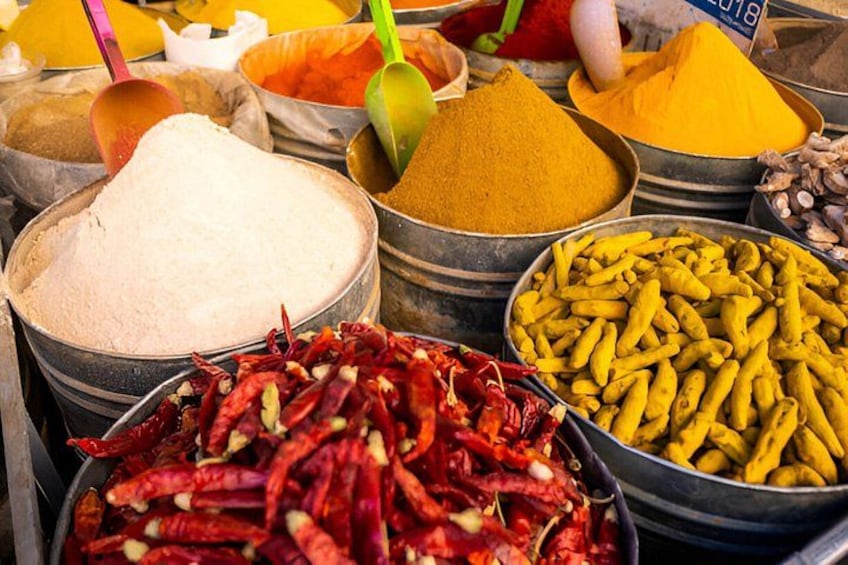 Various spices and dried chilies in metal containers. 5