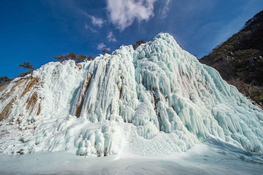 A large ice waterfall cascading down a mountain. 5
