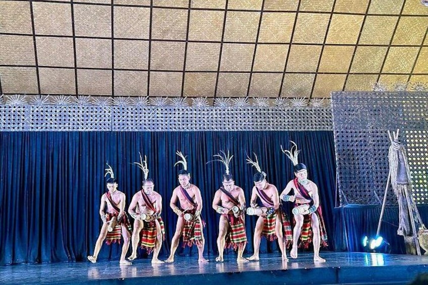 A stage with performers in traditional attire. 2