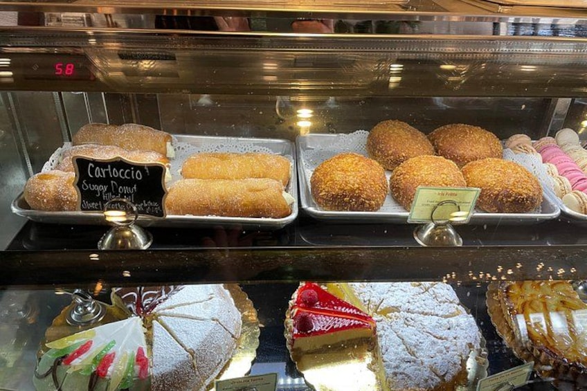 A bakery display with various pastries and desserts. 3