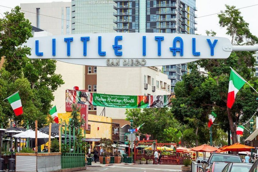 A street sign reading 'Little Italy' with Italian flags and a banner for 'Naiwan Heritage Market.' 5