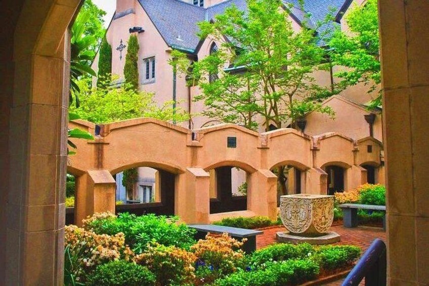 A courtyard with arches, a fountain, and lush greenery. 3