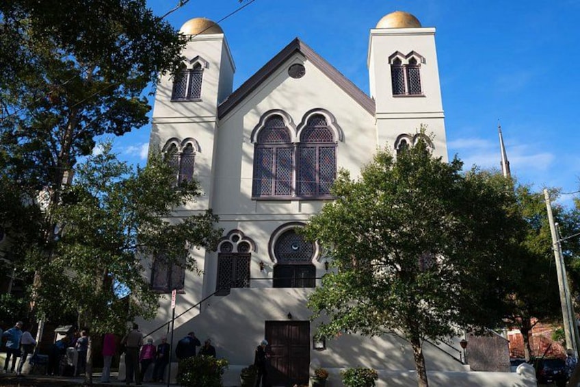 A church with two domed towers, arched windows, and a central entrance. 1