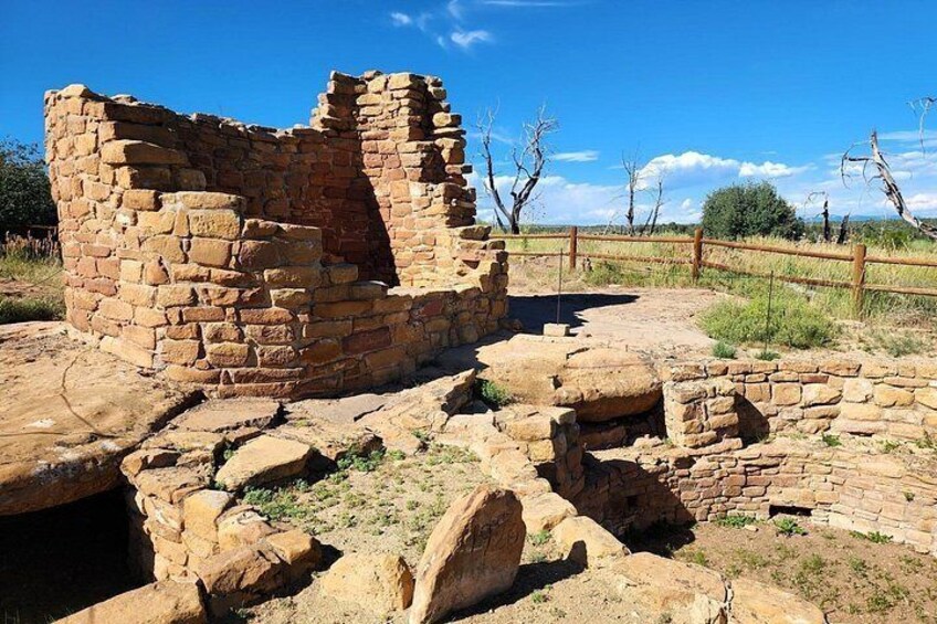 Ancient stone ruins with a wooden fence in the background. 3
