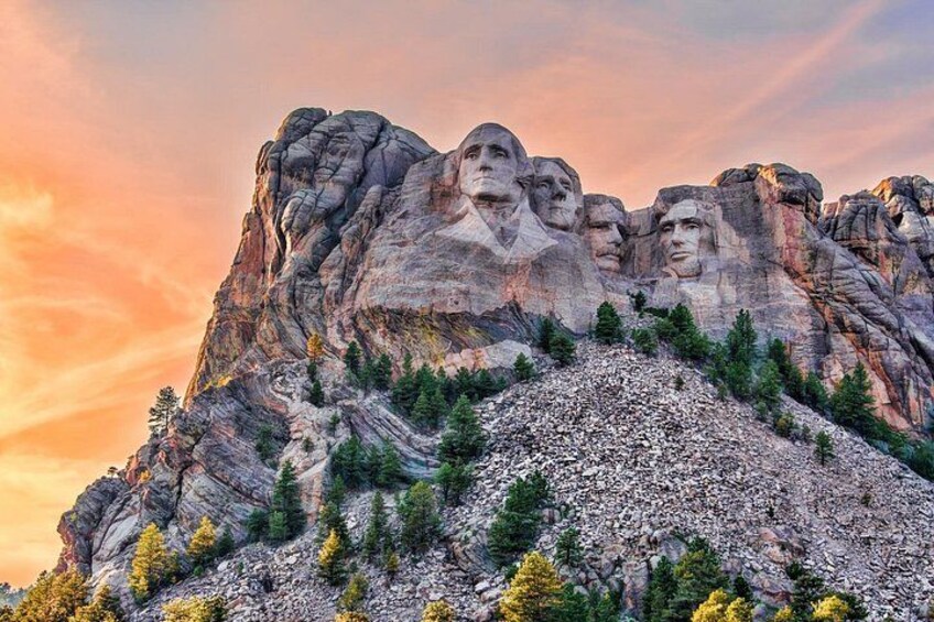 Mount Rushmore with four presidential faces carved into the rock. 2