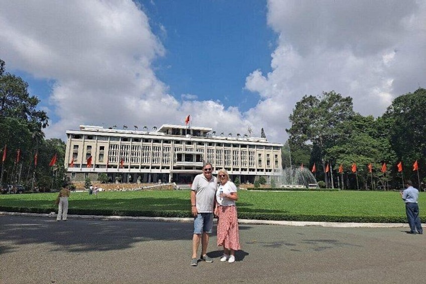 A large building with a fountain in front, surrounded by flags. 2