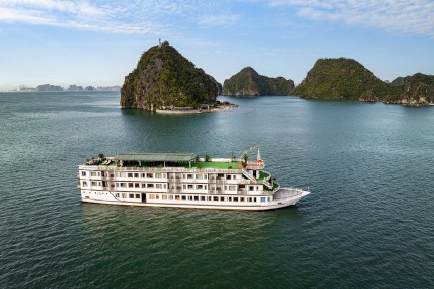 A riverboat on a calm river with lush green islands in the background. 4
