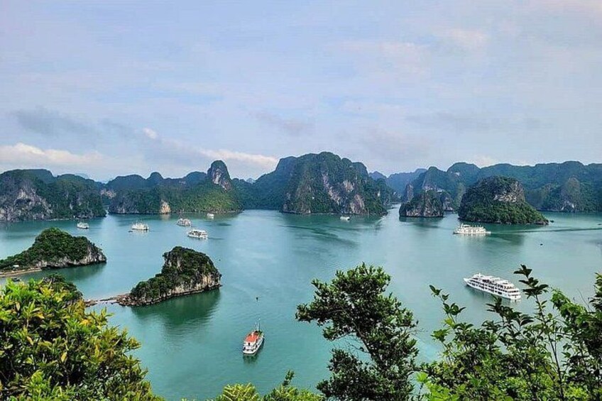 A coastal landscape with multiple islands, calm water, and boats. 5
