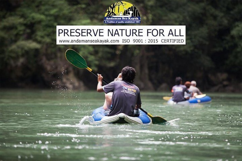 A person kayaking on a river surrounded by greenery. 1