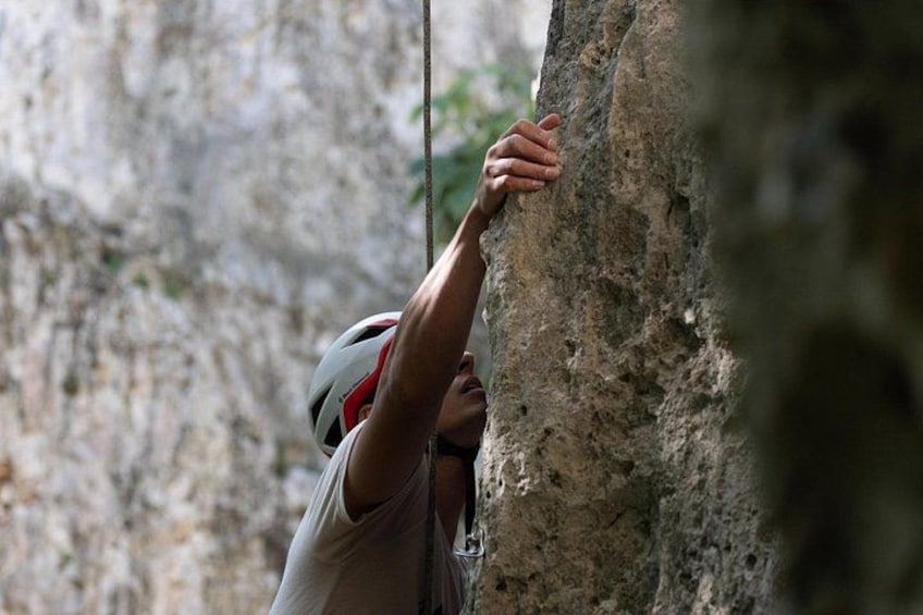 A person climbing a rock face. 3