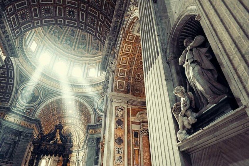 A grand interior with a domed ceiling, columns, and classical statues. 2