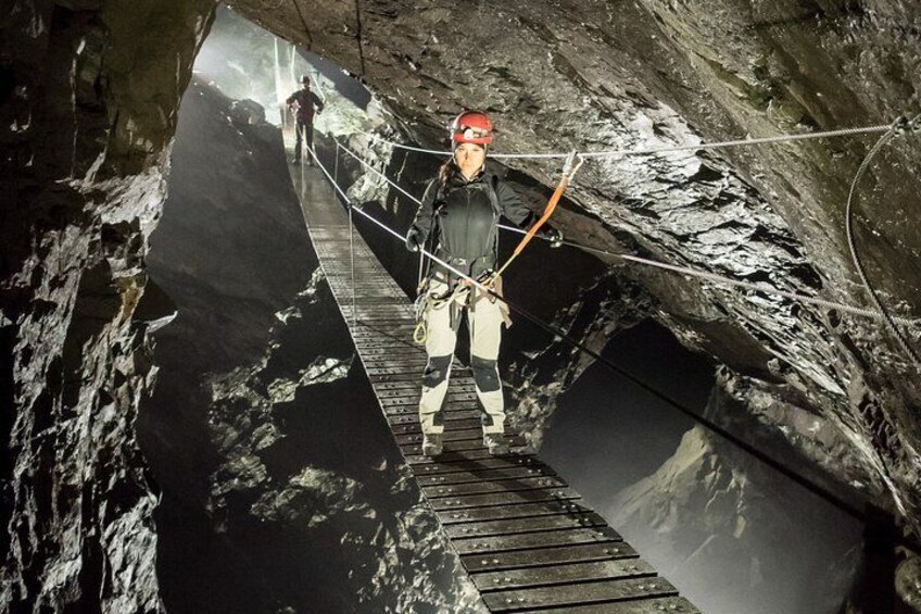 A person rappelling down a rocky cliffside. 1