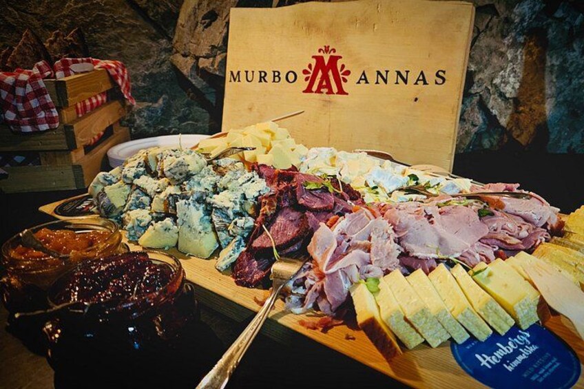 A charcuterie board with various meats, cheeses, and jams. 5