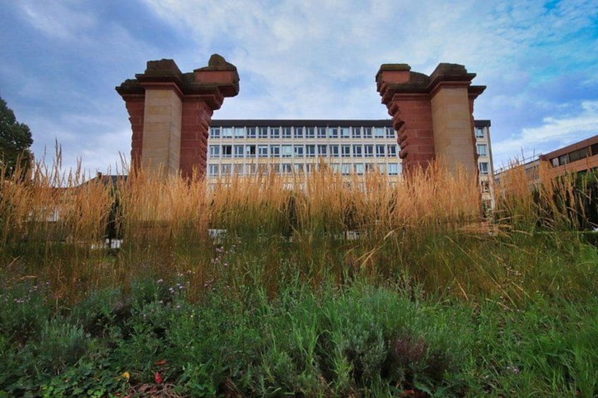 A building with two brick pillars and a modern glass facade. 2
