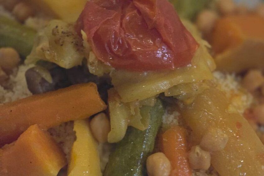 A close-up of a dish with vegetables and chickpeas. 2