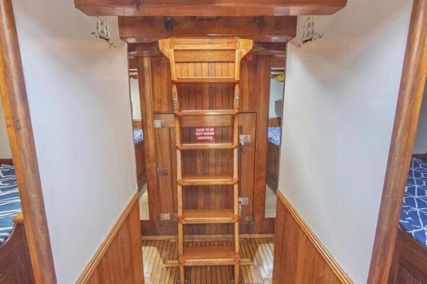 A wooden ladder leading to a door with a warning sign. 2