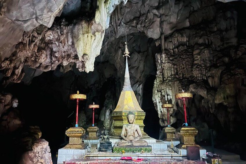 A cave temple with a central stupa, surrounded by smaller stupas and ornate decorations. 5