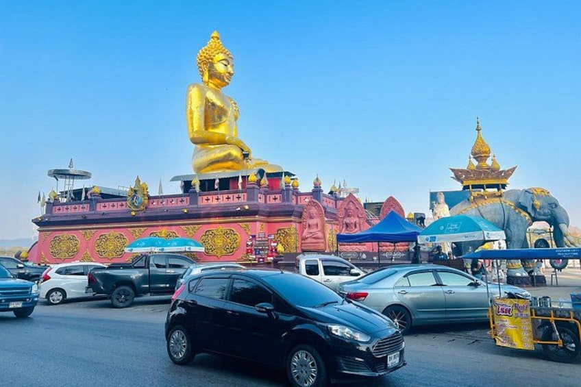 A large golden Buddha statue, a temple with a golden spire, and a blue elephant statue. 3
