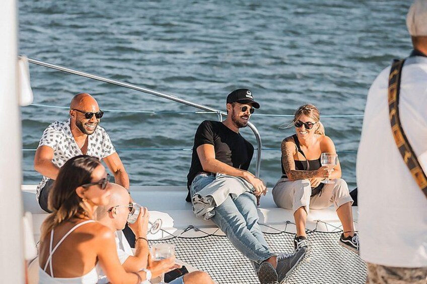 A group of people on a boat with a body of water in the background. 2