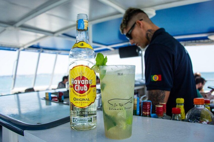 A bottle of Havana Club Original rum and a mojito on a table. 3