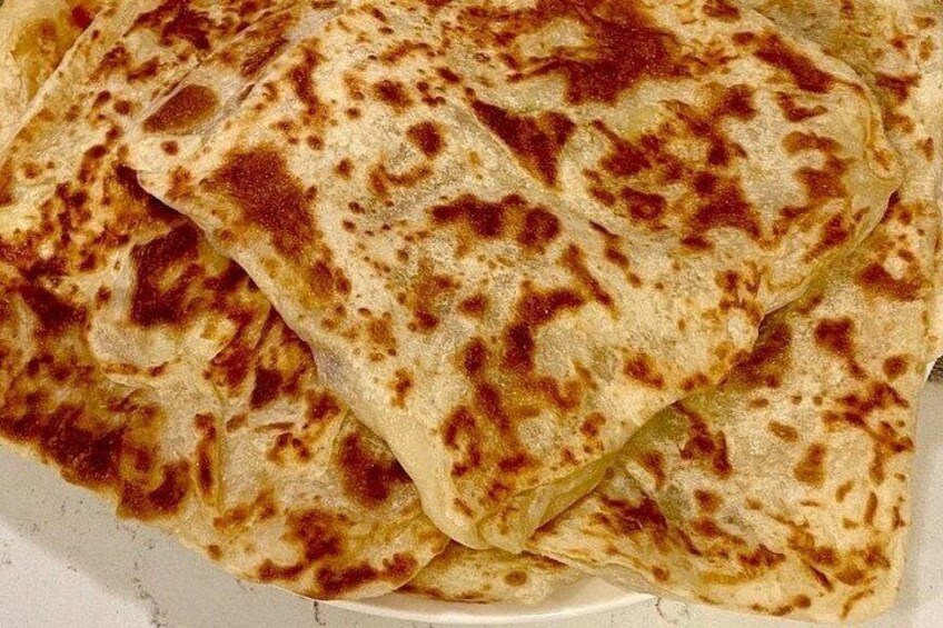 A stack of flatbreads with brown spots, likely from cooking. 4