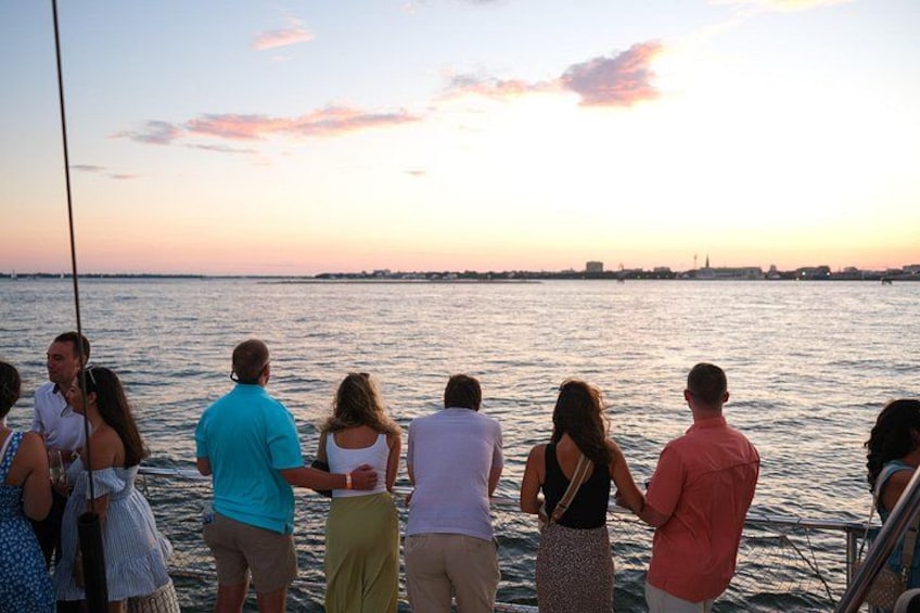A group of people on a boat at sunset. 5