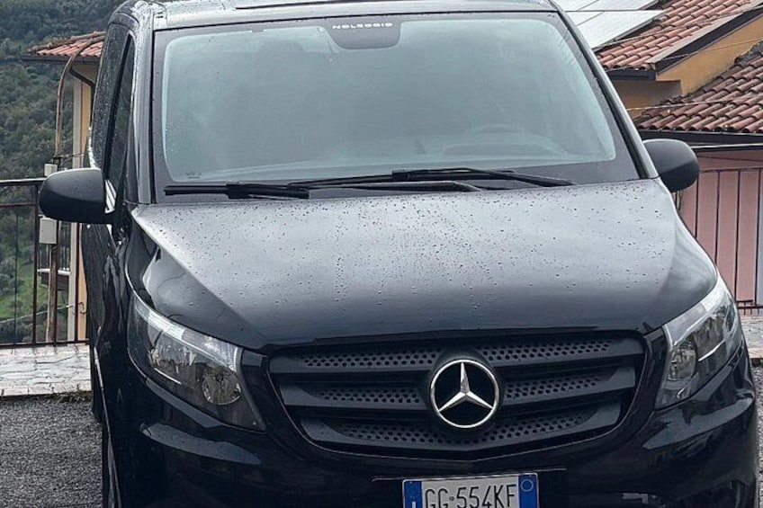 A black Mercedes-Benz SUV parked outdoors with a visible license plate. 1