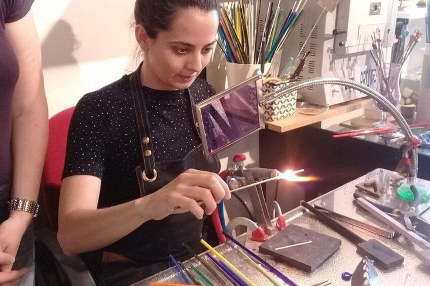 A person working with a soldering iron and various tools on a workbench. 4