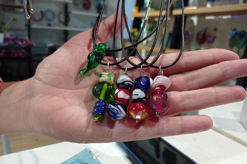 A hand holding colorful glass beads and charms. 2