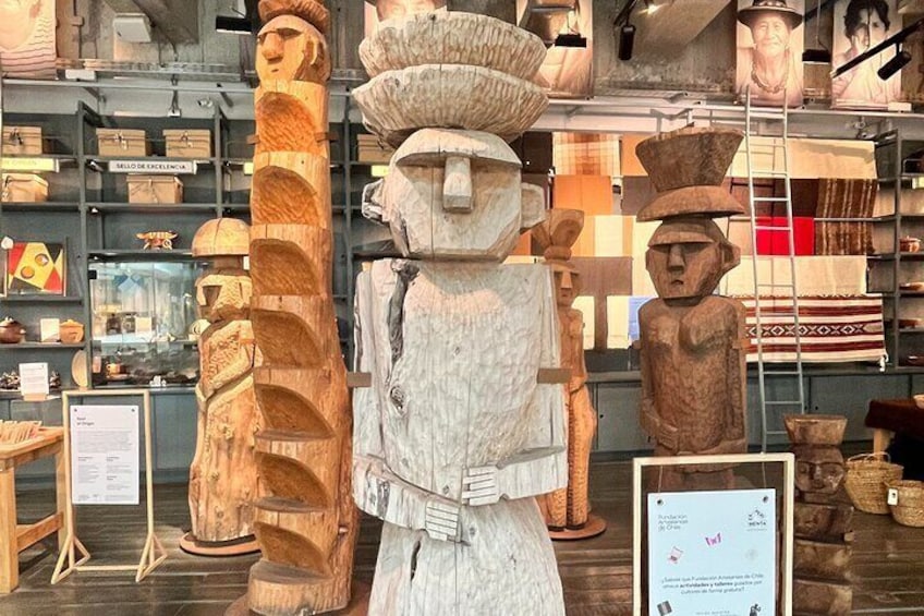 A museum display of wooden sculptures and artifacts. 5