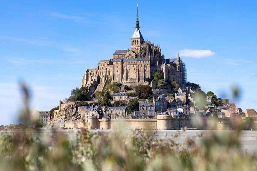 A historic castle on a hill with a clear sky. 1