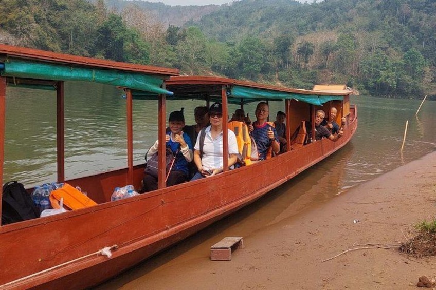 A wooden boat with passengers on a river. 3