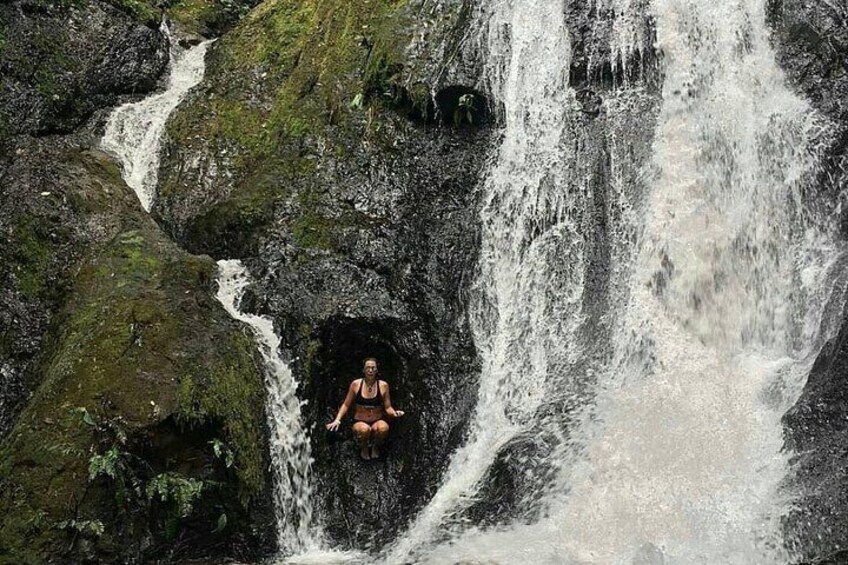 A person meditating in a natural setting with a waterfall. 2