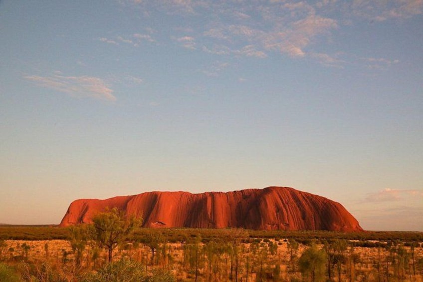 Uluru bij zonsondergang onder een heldere hemel. 4