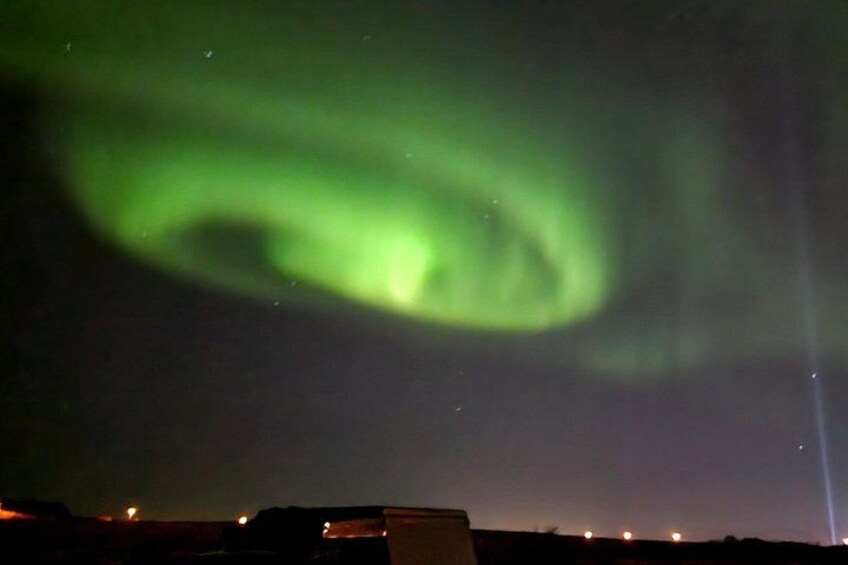 The Northern Lights over a landscape with buildings. 3