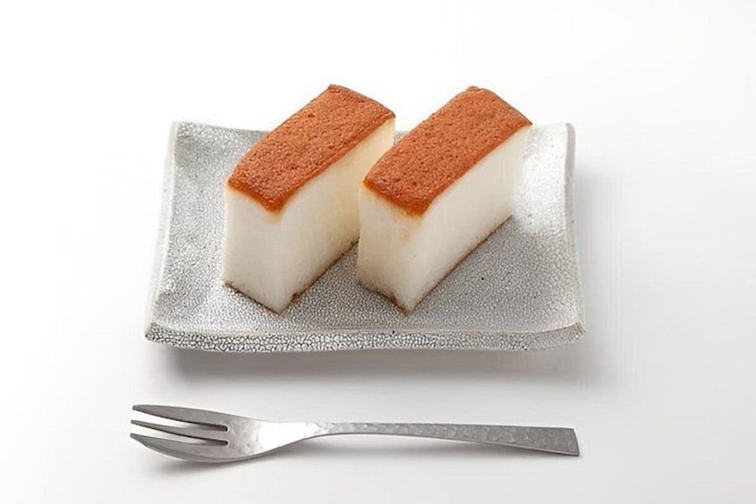 Two rectangular desserts on a silver plate with a fork beside them. 5
