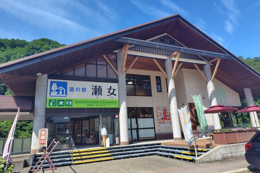 A building with a sign for 'Specialty goods & Souvenirs' and a covered entrance. 4