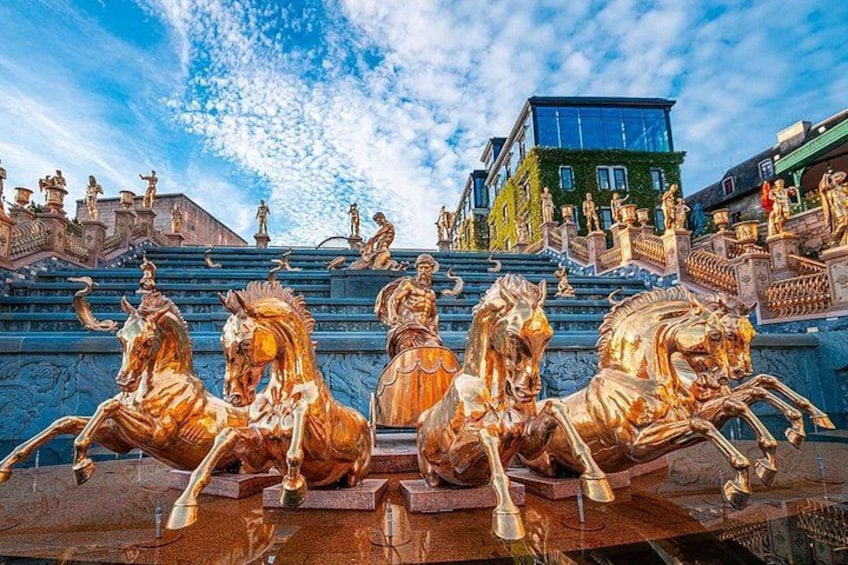 Una serie de estatuas doradas de caballos en una escalera. 2