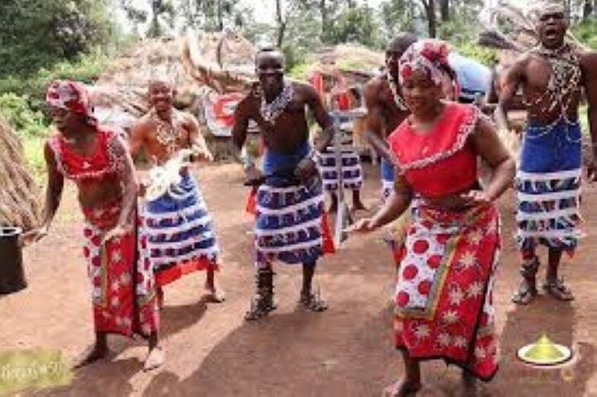 People in traditional attire, a dirt path, and a natural setting. 3
