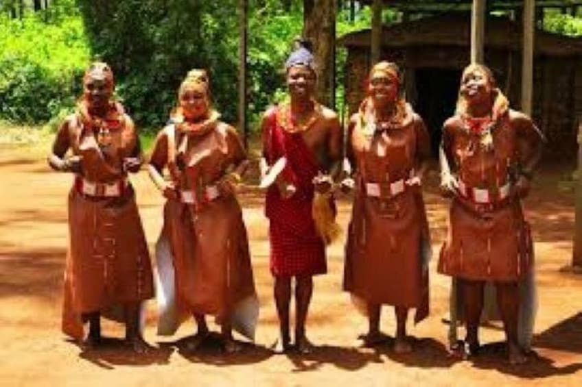 A group of people in traditional attire standing outdoors. 2