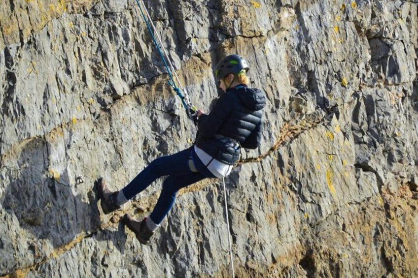 A person rock climbing on a rugged cliff. 2