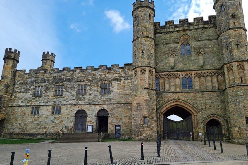 A historic stone building with multiple towers and arched windows. 1