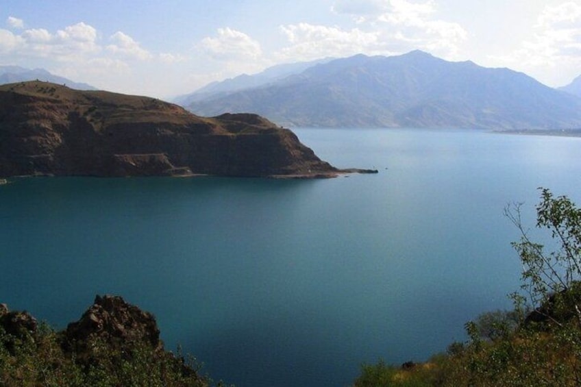 A large body of water surrounded by hills and mountains. 4