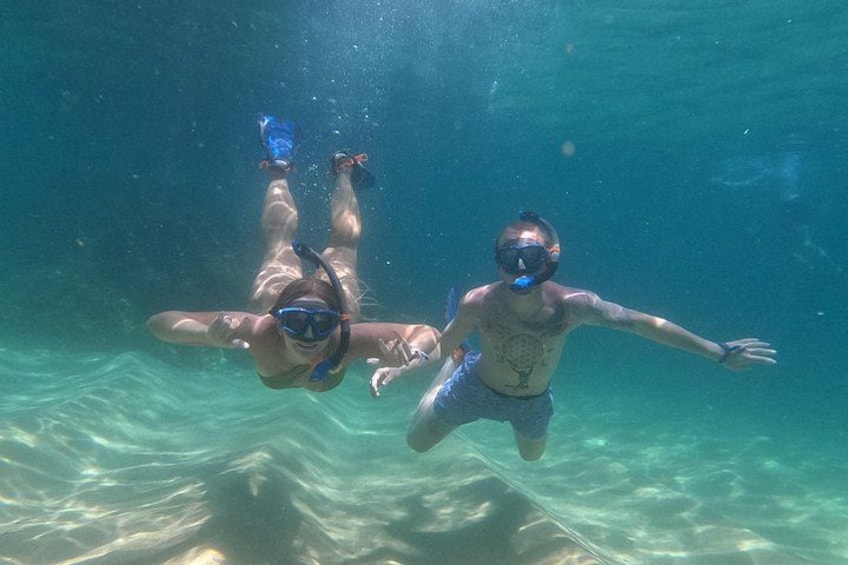 Two people snorkeling underwater. 5