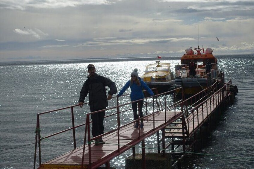 A pier with a boat docked at the end. 3