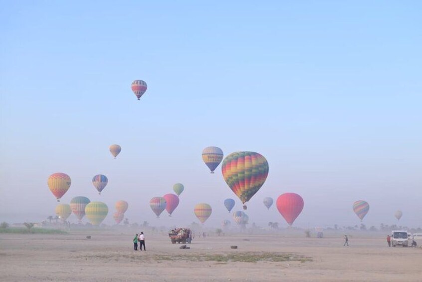 A hot air balloon festival with multiple colorful balloons in the sky. 3