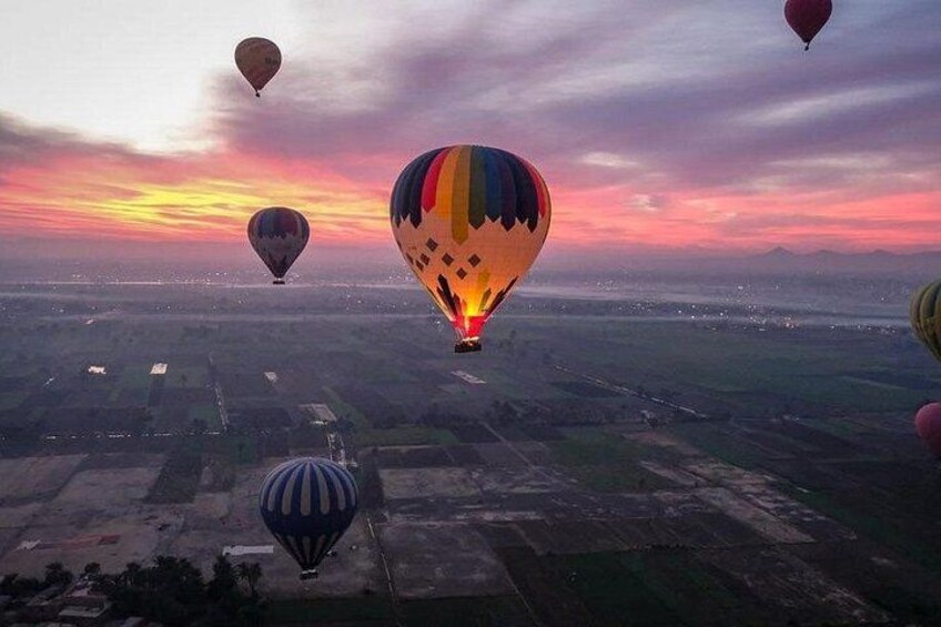 Hot air balloons over a landscape at sunset. 2