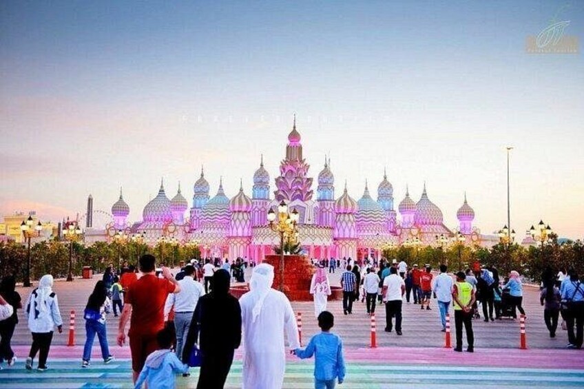 A large, colorful building with multiple domes and a crowd of people in front. 2