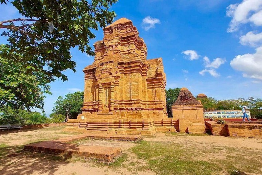 An ancient temple with intricate carvings, surrounded by trees and a clear sky. 5