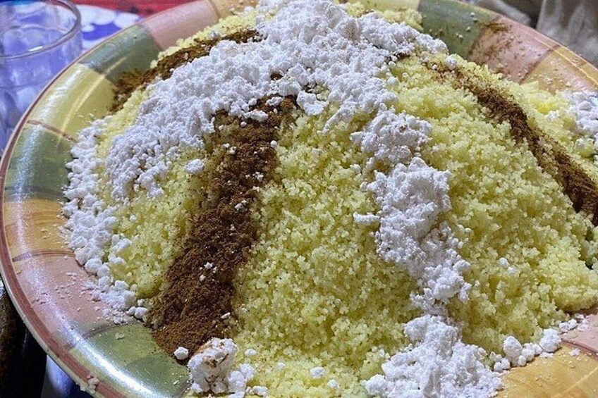 A bowl of couscous with powdered spices. 5